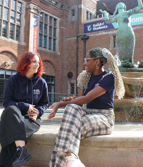 two students talking in mermaid square