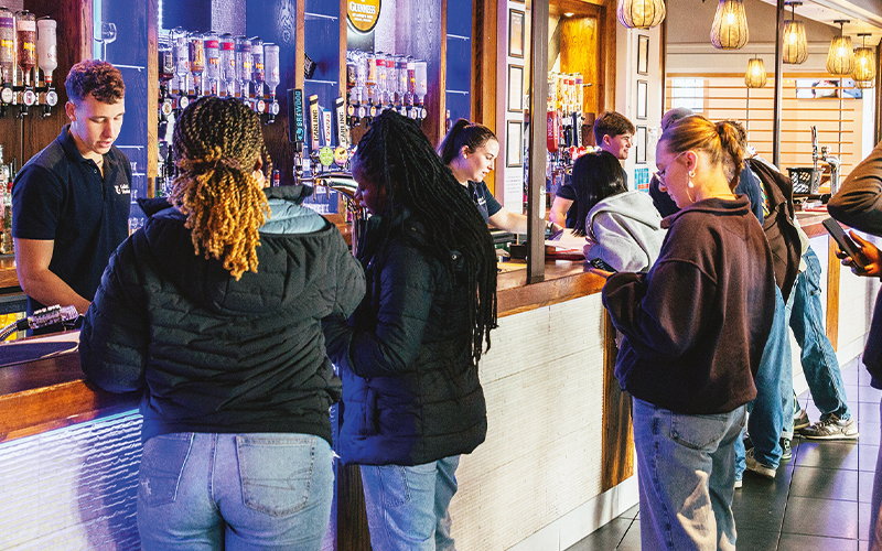 an image of students in joe's bar