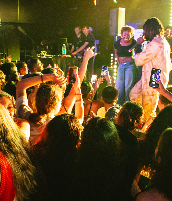 students singing in a crowd at a club night