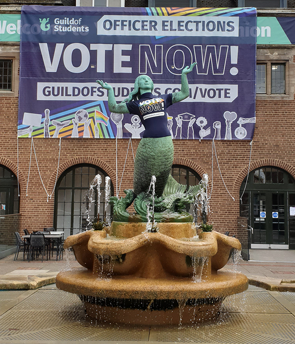 the guild mermaid with a vote t-shirt