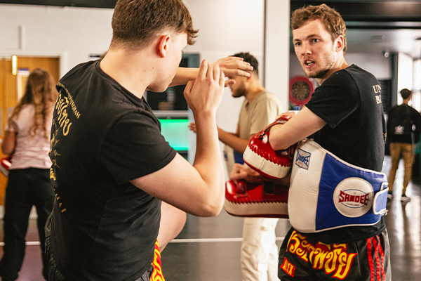 students involved in a kick boxing class