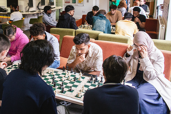 students playing chess in guild reception