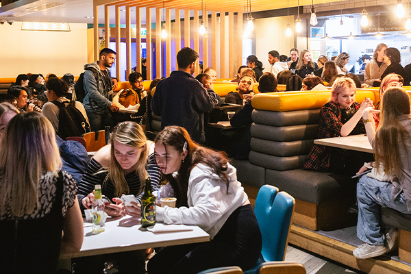 wide shot of students at a postgraduate mixer