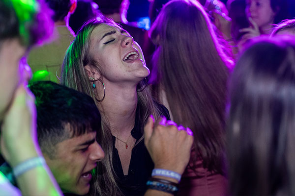 a student singing in a crowd