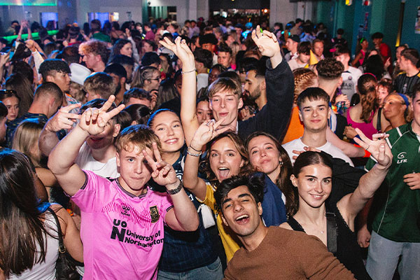 students in a crowd dancing at sports night