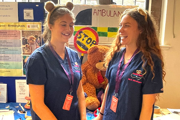 students at a stand at medsoc fair