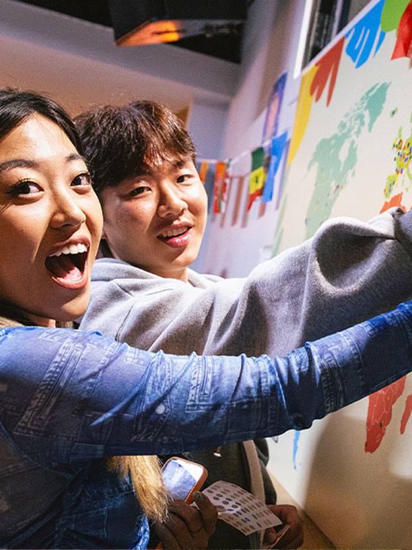 a picture of students pointing at a map